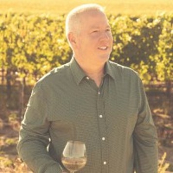 Portrait of Timothy Allen standing in the vineyard
